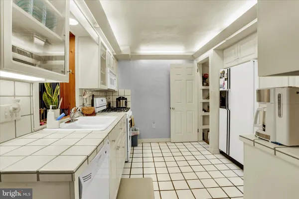 a view of a kitchen with appliances and cabinets