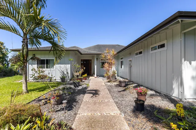 a view of a house with backyard and sitting area