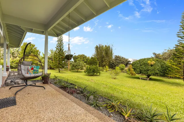 a view of a swimming pool with a lawn chairs under an umbrella