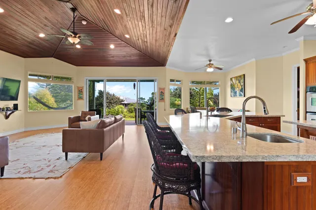 a dining room with furniture a large window and a chandelier
