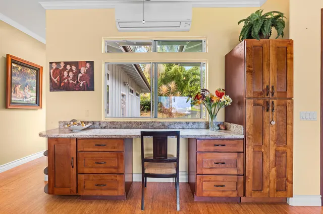 a kitchen with a wooden floor and a refrigerator