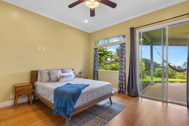 a spacious bedroom with a large bed and a chandelier