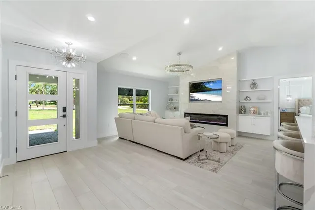 a living room with furniture and a kitchen