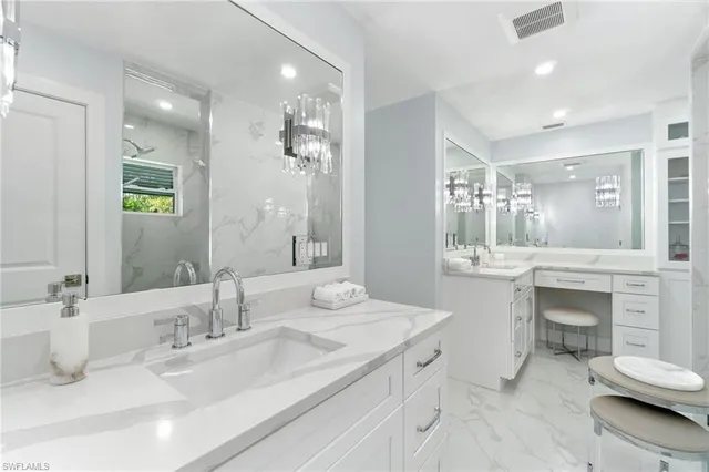 a bathroom with a granite countertop sink mirror and toilet