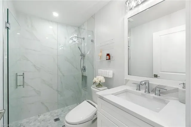 a bathroom with a sink toilet and shower