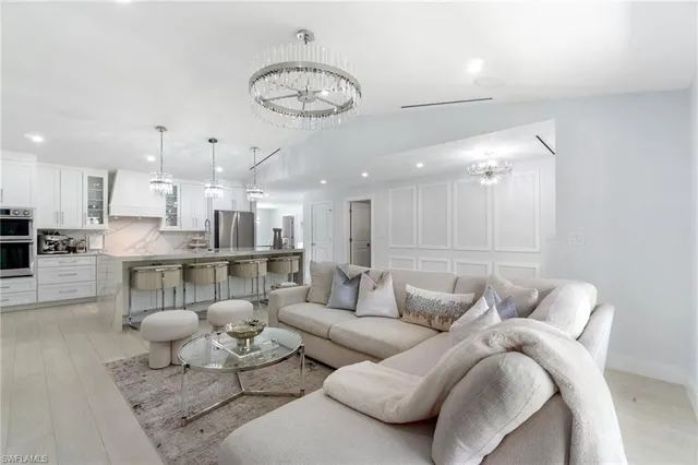 a living room with furniture and kitchen view