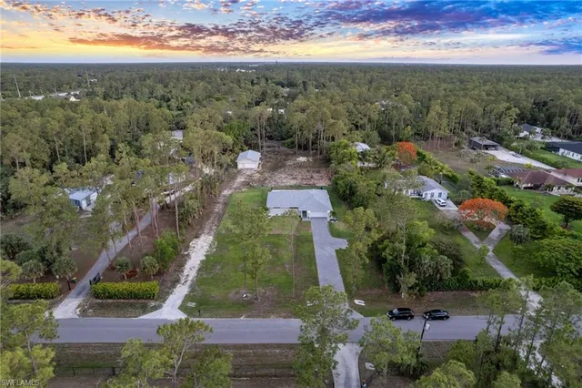 an aerial view of residential houses with outdoor space and street view
