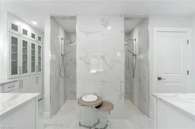 a bathroom with a granite countertop sink a toilet and shower