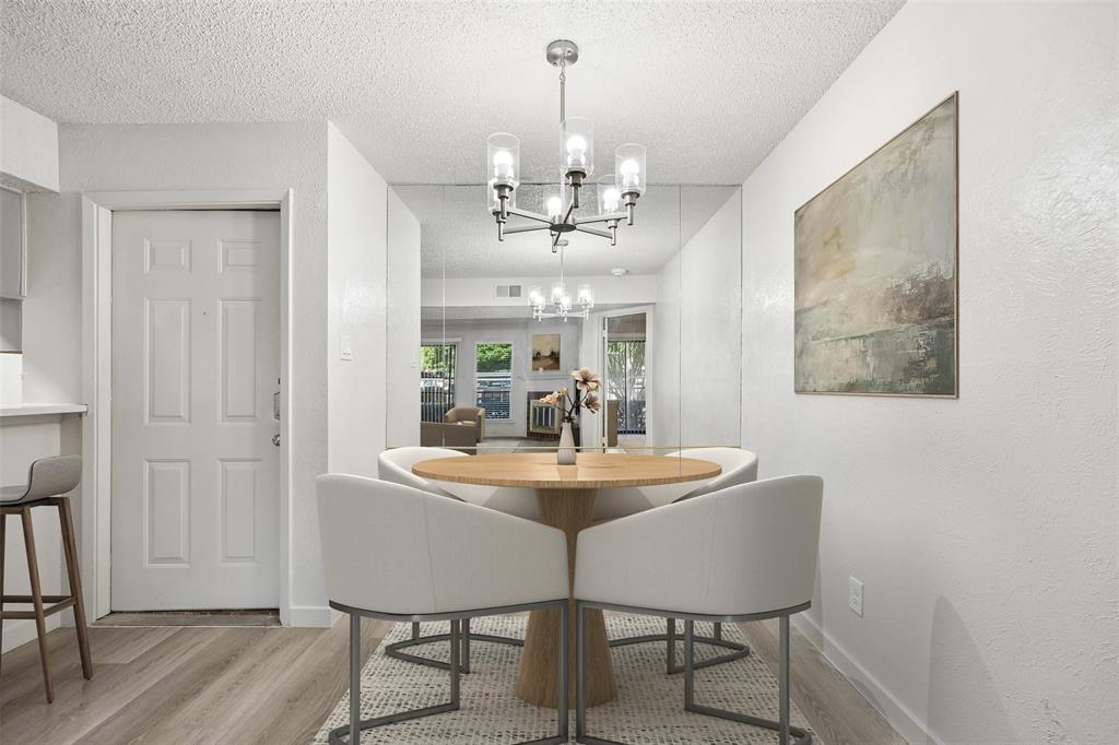11480 Audelia Road, Unit 136 Dallas, TX 75243 - Photo 6 of 29 Dining area featuring wood-finish flooring and a contemporary chandelier