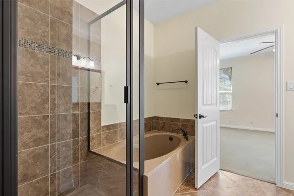 a bathroom with a bathtub and shower