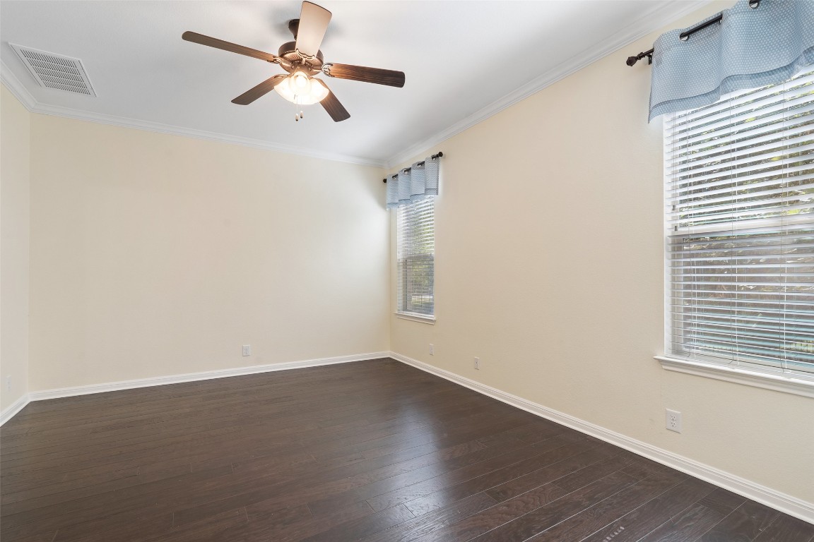9412 Solana Vista Loop, Unit B Austin, TX 78750 - Photo 17 of 25 a view of a room with wooden floor and a ceiling fan