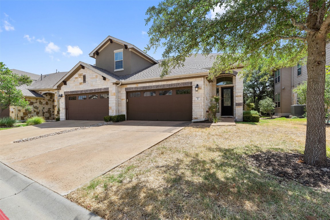 9412 Solana Vista Loop, Unit B Austin, TX 78750 - Photo 2 of 25 a front view of a house with a yard