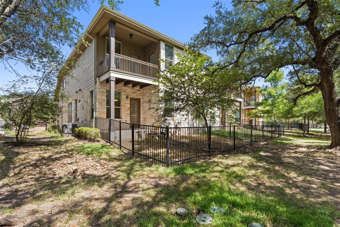 9412 Solana Vista Loop, Unit B Austin, TX 78750 - Photo 22 of 25 a backyard of a house with lots of green space