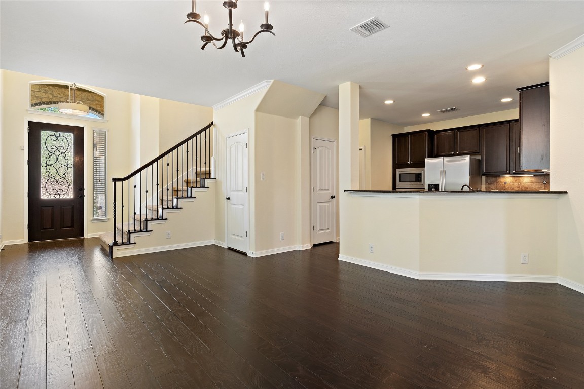 9412 Solana Vista Loop, Unit B Austin, TX 78750 - Photo 4 of 25 a view of a kitchen with wooden floor and electronic appliances