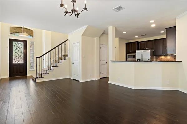 a view of a kitchen with wooden floor and electronic appliances