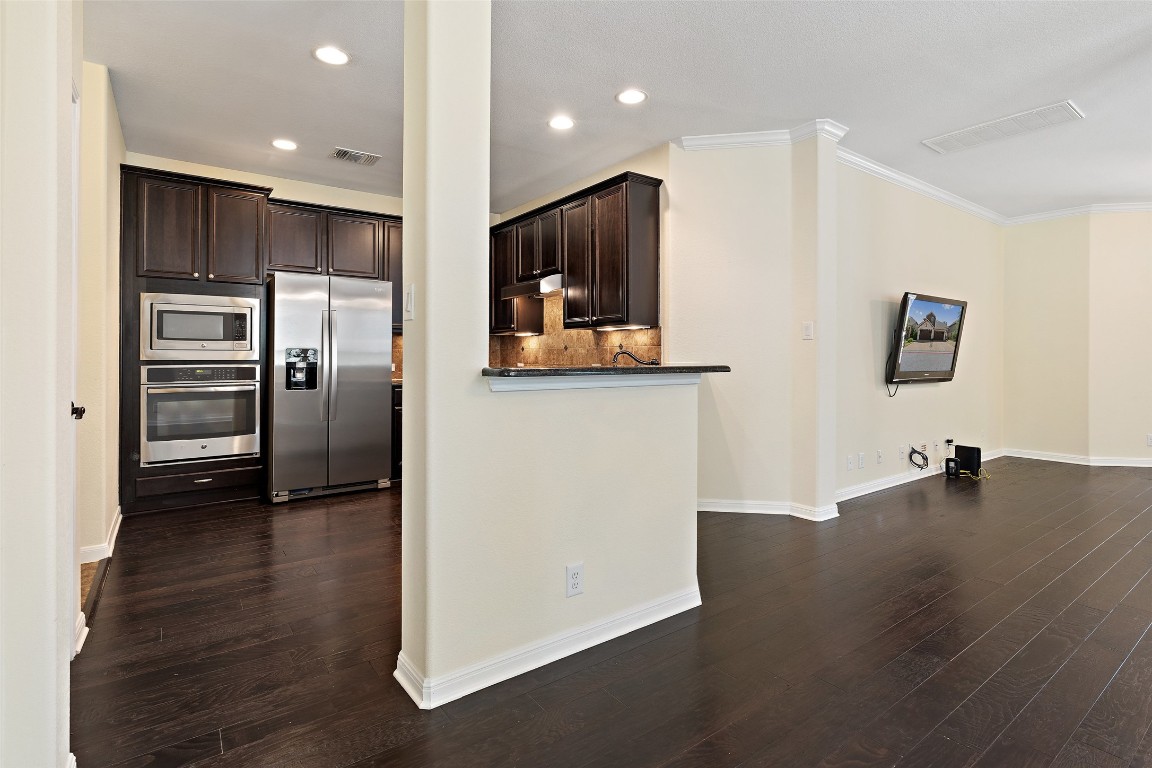 9412 Solana Vista Loop, Unit B Austin, TX 78750 - Photo 5 of 25 a view of a kitchen with a refrigerator and a stove top oven