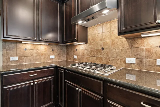 a kitchen with granite countertop a stove and a sink