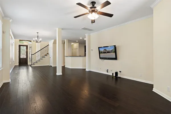 a view of a room with wooden floor and white walls