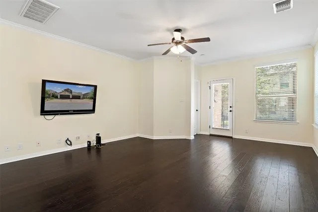 a view of a room with wooden floor and fan