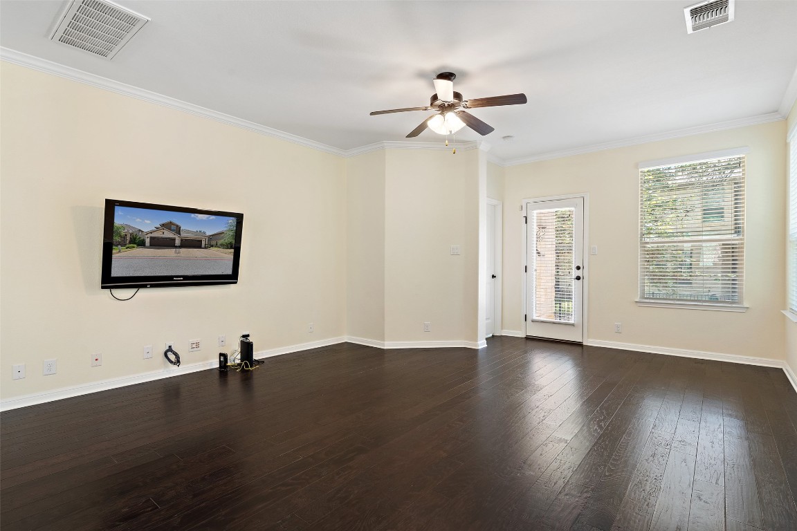 9412 Solana Vista Loop, Unit B Austin, TX 78750 - Photo 9 of 25 a view of a room with wooden floor and fan
