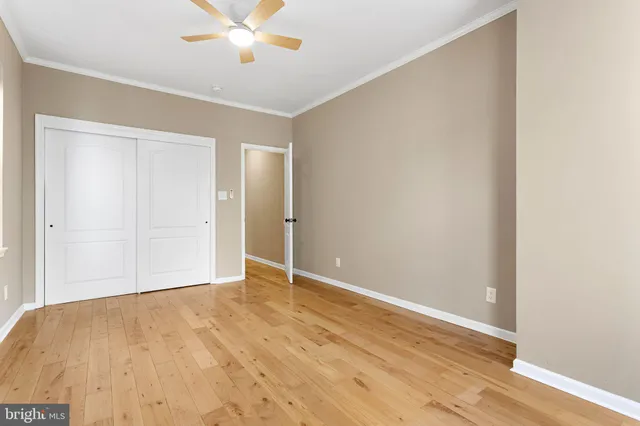 a view of an empty room with wooden floor