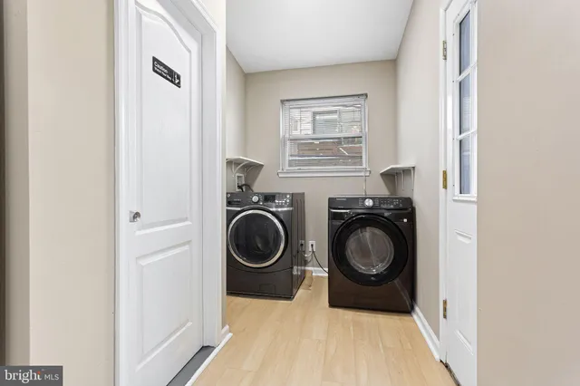 a utility room with sink dryer and washer