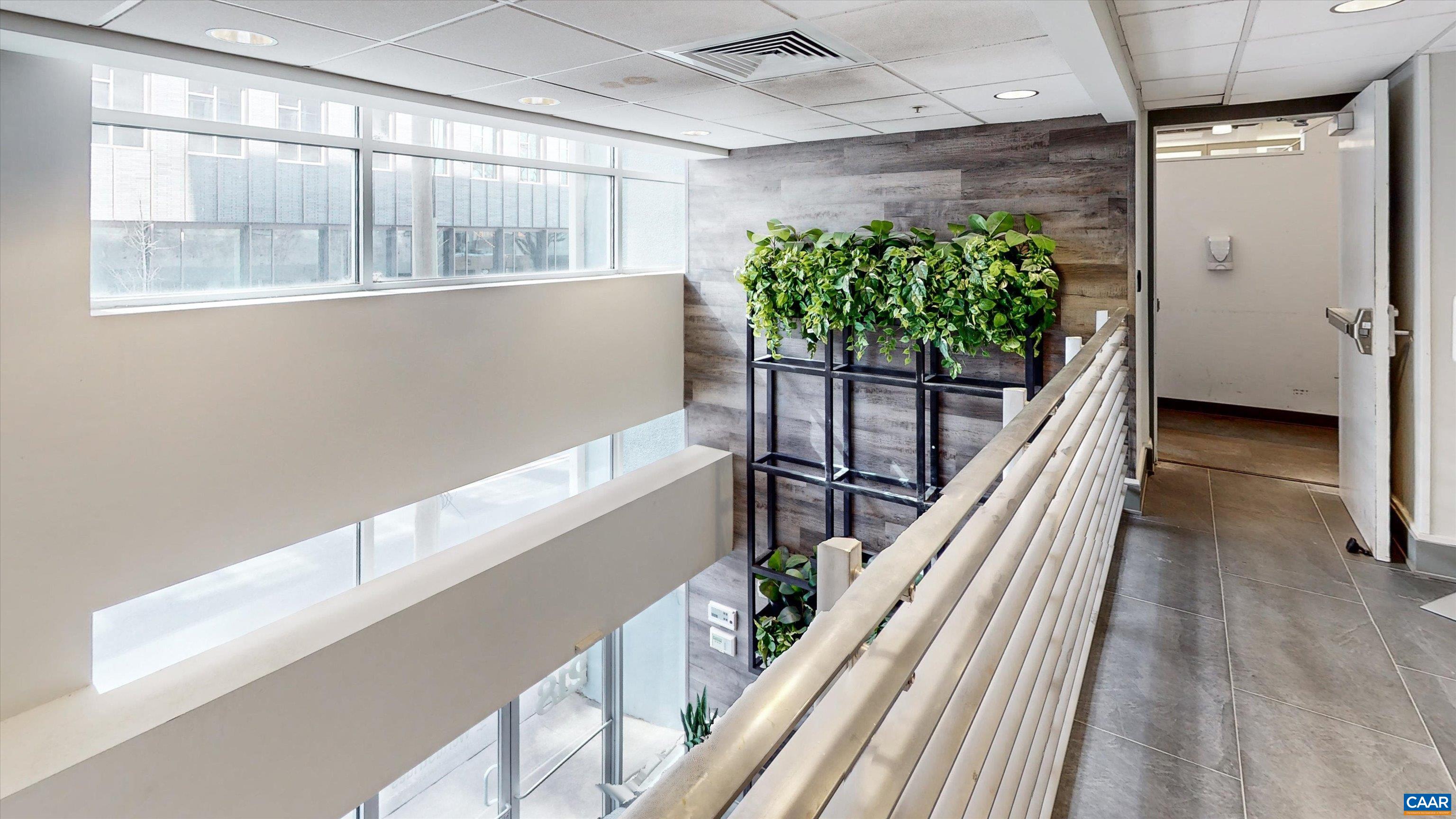 218 West Water Street Charlottesville, VA 22902 - Photo 9 of 16 a hallway with wooden floor and stairs