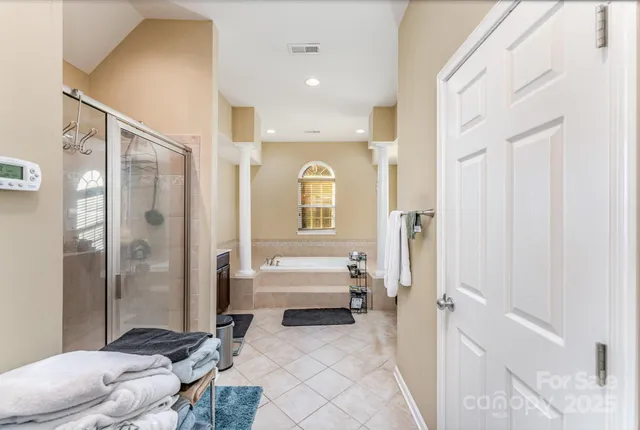 a spacious bathroom with a bathtub shower and toilet