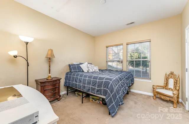 a bedroom with a bed a table and chair