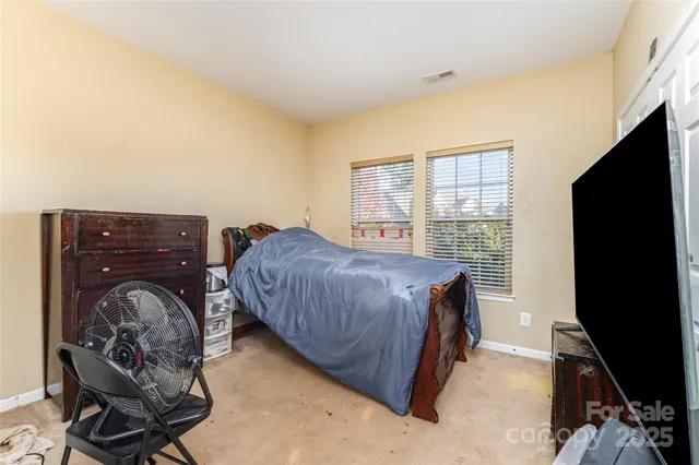 a bed room with a bed and a television