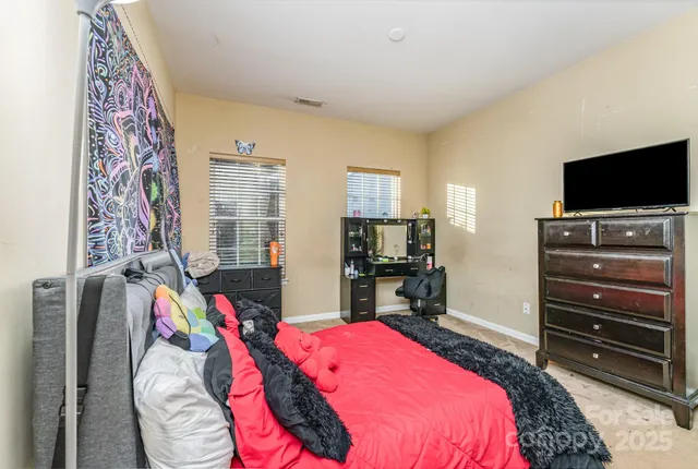 a bedroom with a bed and a flat screen tv