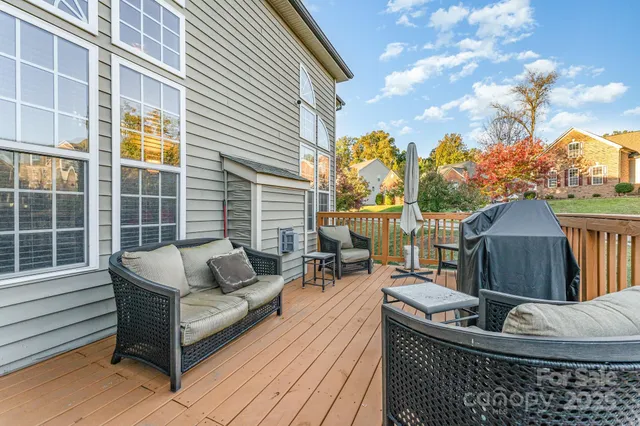 a roof deck with couches and wooden floor