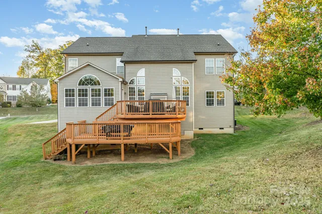 a front view of a house with a garden and deck