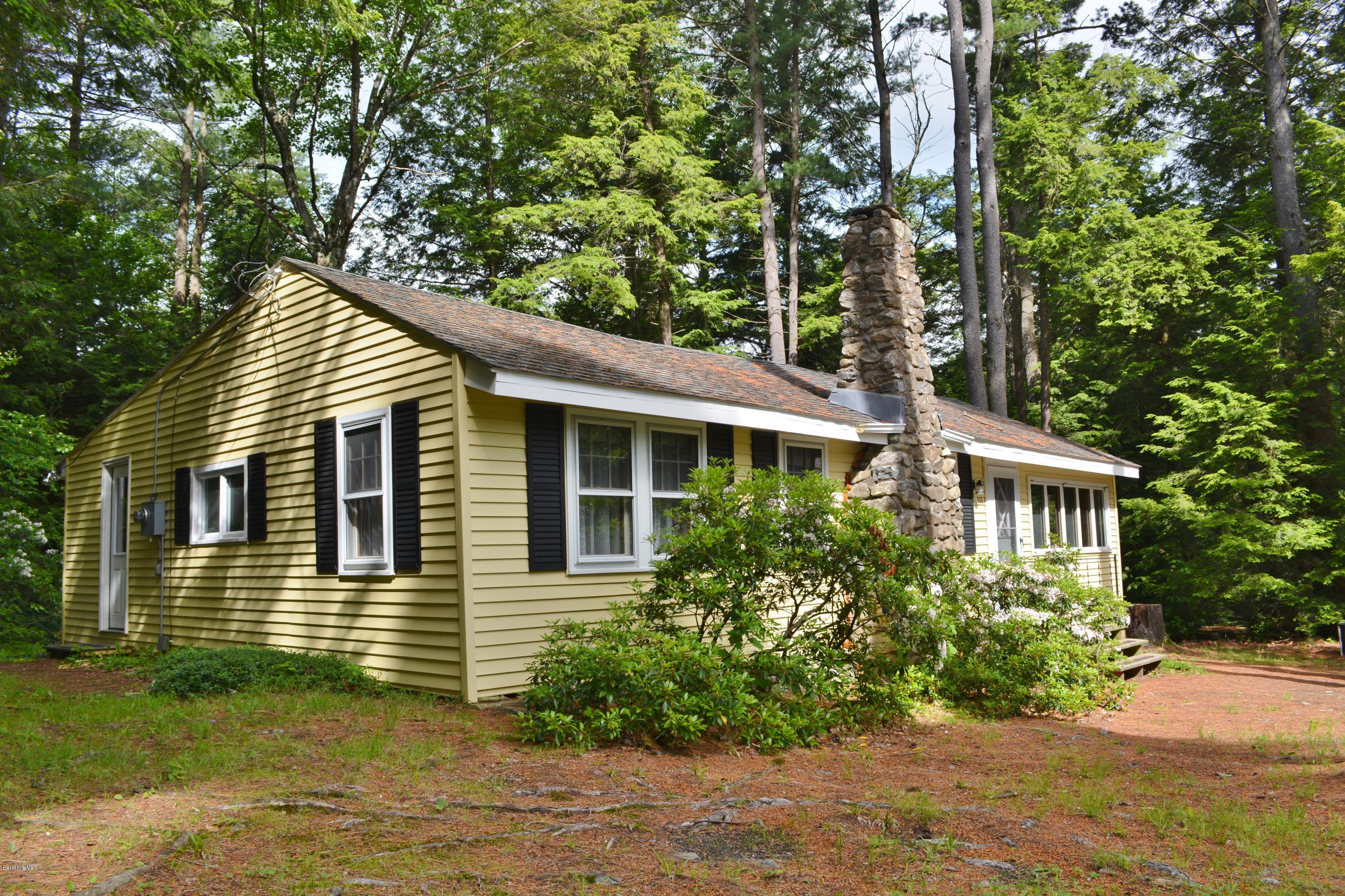 386 Pine Road Otis, MA 01029 - Photo 11 of 12 a front view of a house with a yard and potted plants