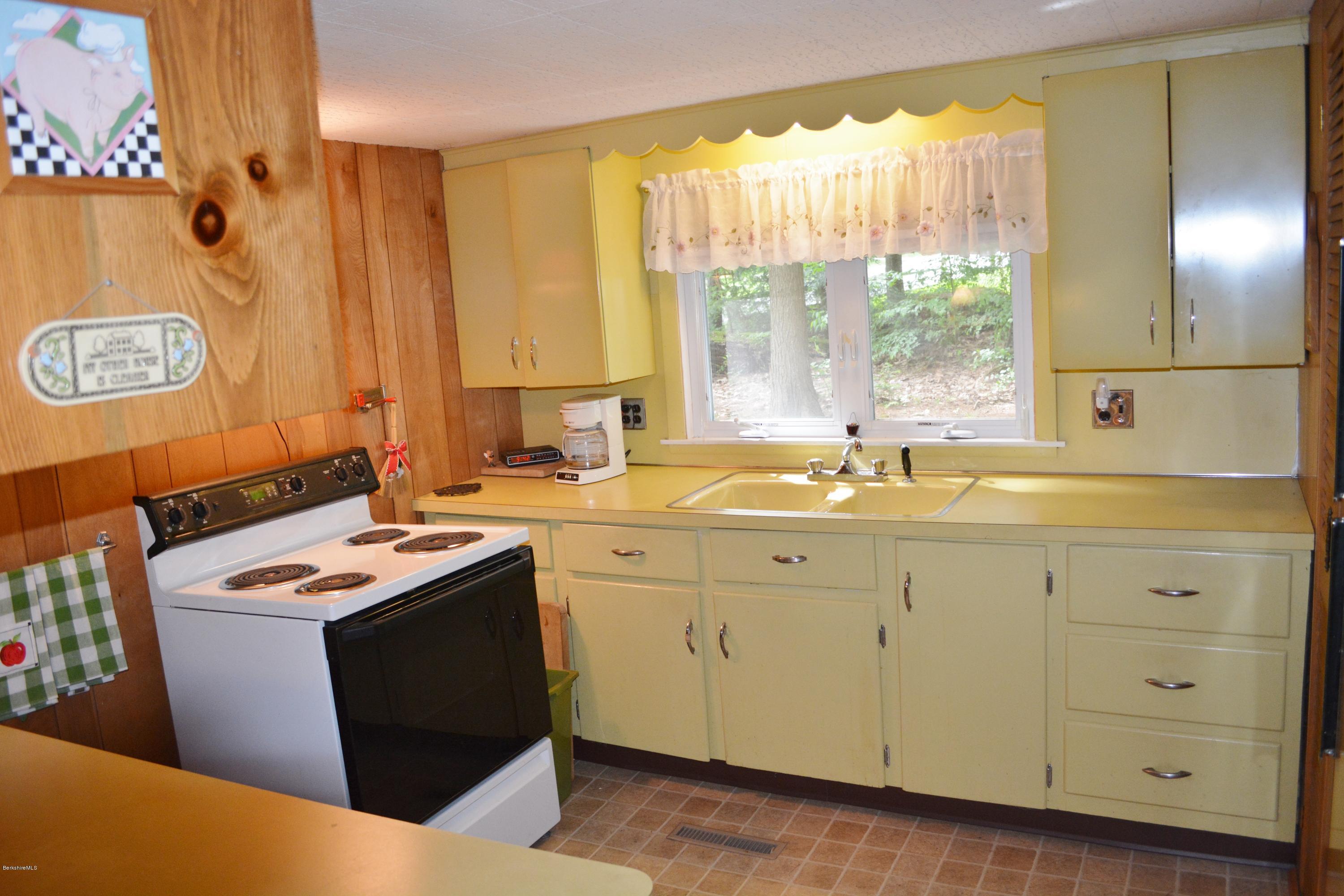 386 Pine Road Otis, MA 01029 - Photo 5 of 12 a room with a sink cabinets and a window