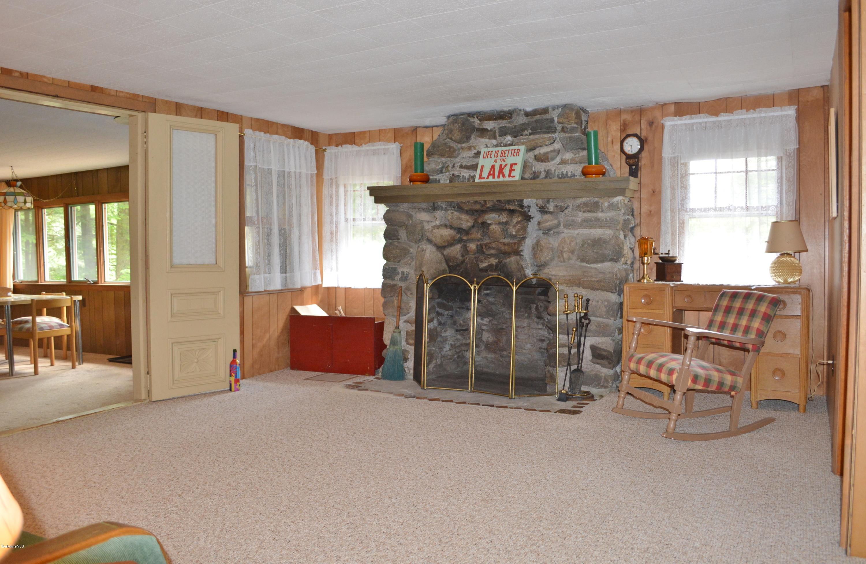 386 Pine Road Otis, MA 01029 - Photo 7 of 12 a living room with furniture and a fireplace