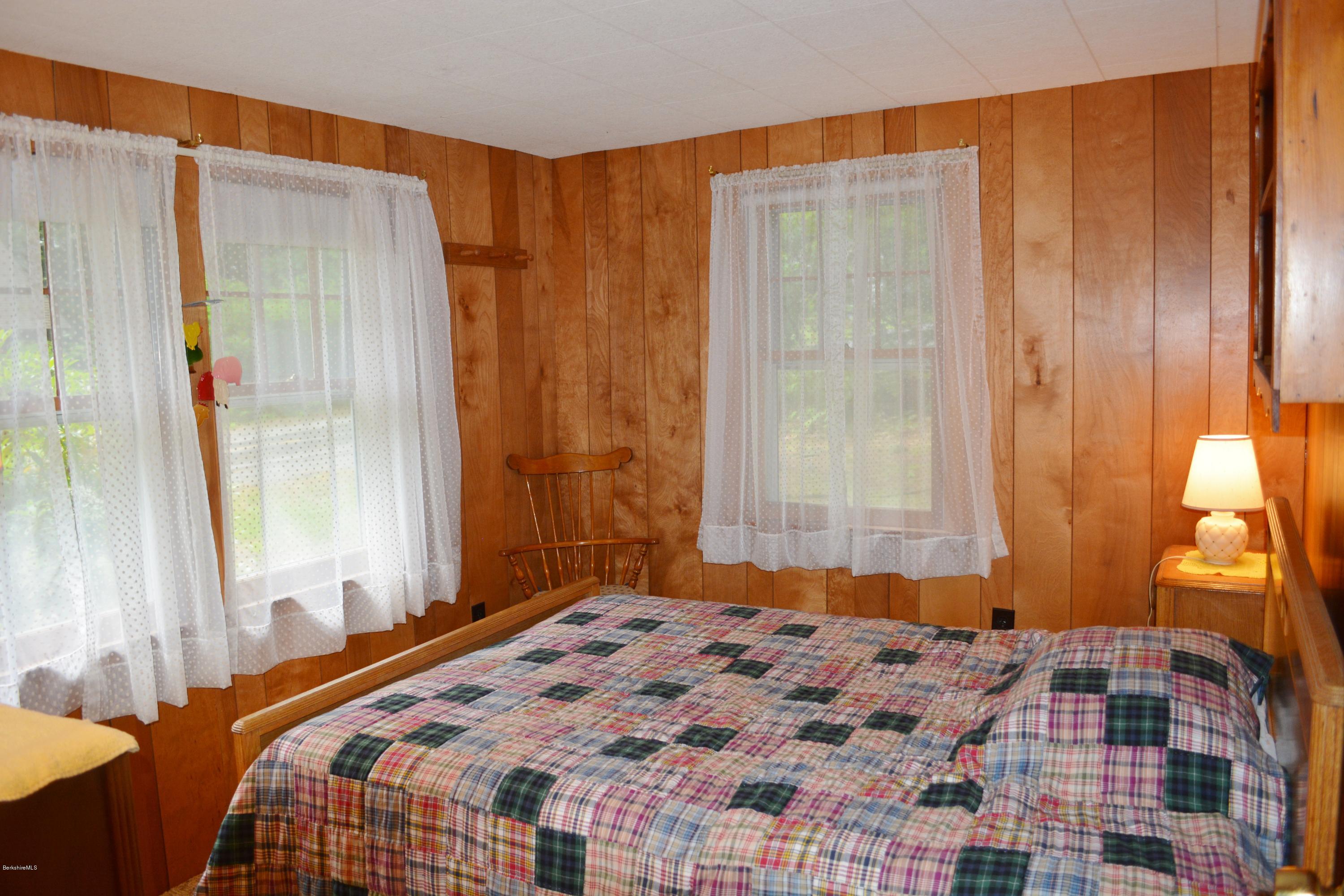 386 Pine Road Otis, MA 01029 - Photo 10 of 12 a bedroom with a bed and a window