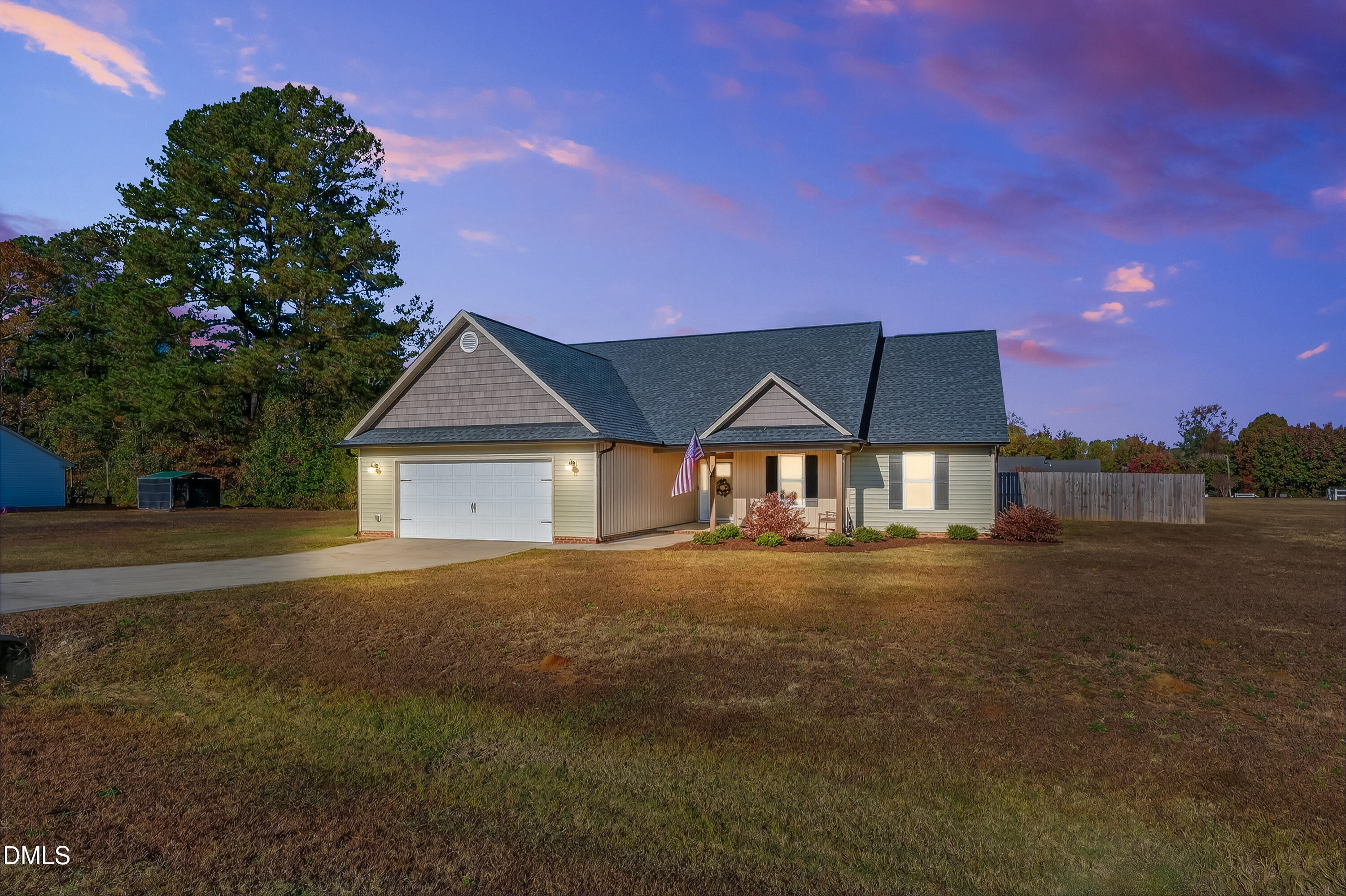a view of a house with a yard and garage