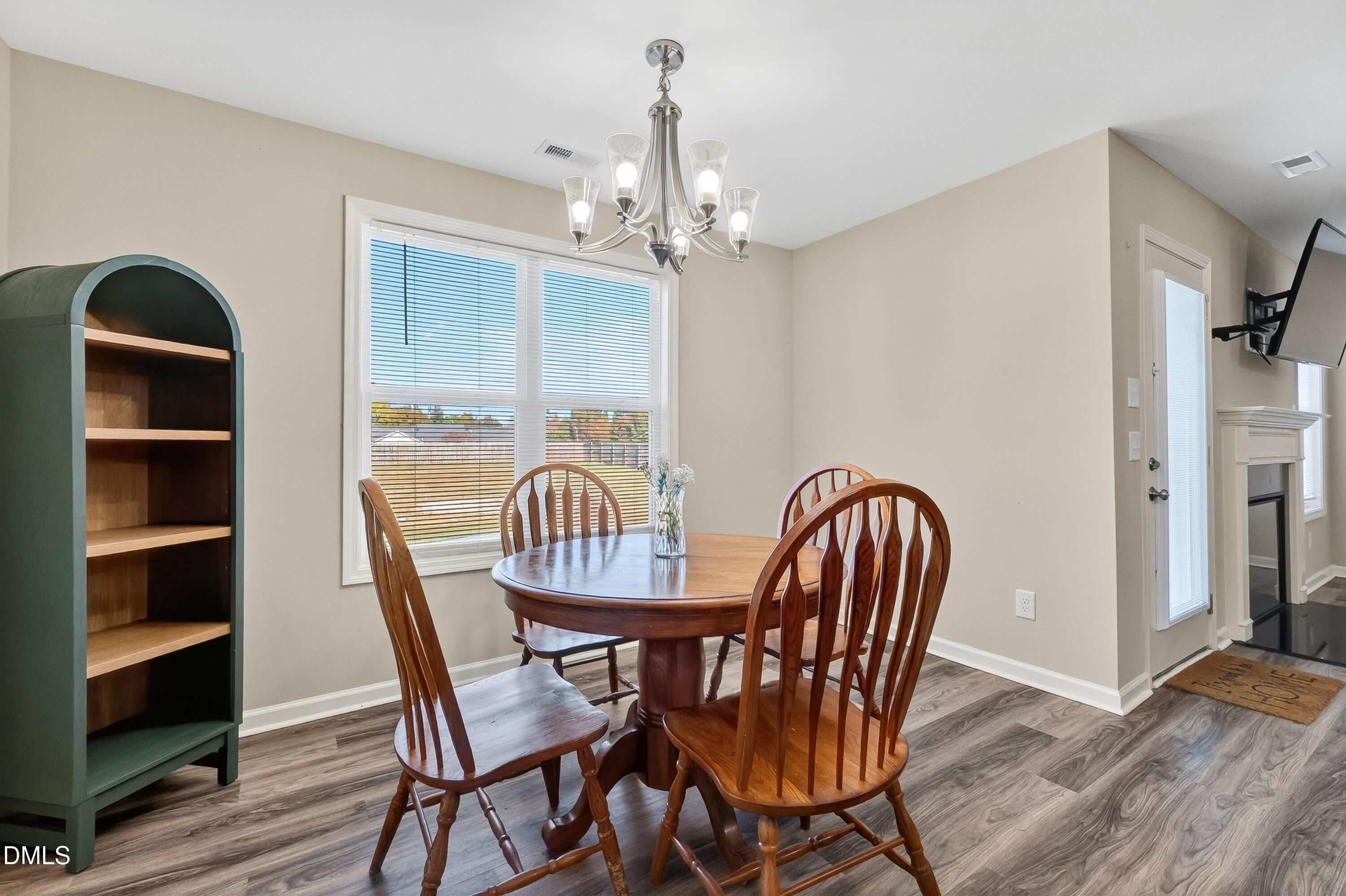 79 Ramble Falls Lane Erwin, NC 28339 - Photo 15 of 46 a dining room with furniture a chandelier and wooden floor