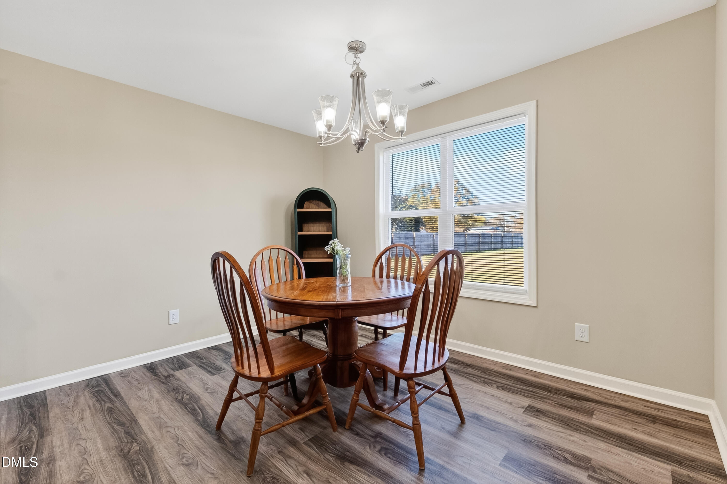 79 Ramble Falls Lane Erwin, NC 28339 - Photo 22 of 46 a view of a dining room with furniture a chandelier and wooden floor