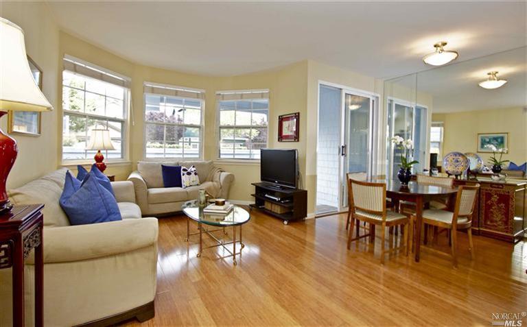 55 Mariners Circle San Rafael, CA 94903 - Photo 1 of 1 a living room with furniture and a flat screen tv with wooden floor