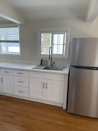 a kitchen with a refrigerator and window