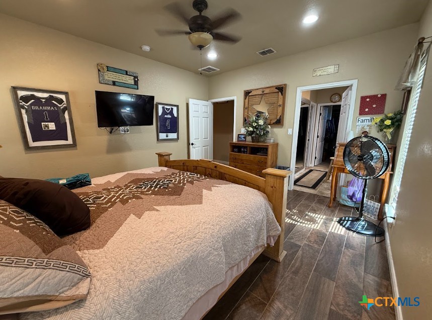 609 Highway 123 Stockdale, TX 78160 - Photo 14 of 26 a bedroom with a bed and a flat screen tv
