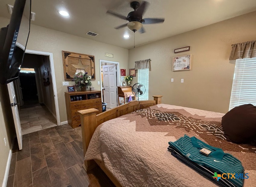 609 Highway 123 Stockdale, TX 78160 - Photo 16 of 26 a bedroom with a bed dresser and a window