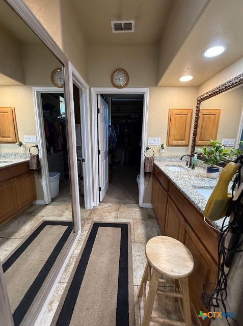 609 Highway 123 Stockdale, TX 78160 - Photo 17 of 26 a bathroom with a sink a mirror and a shower