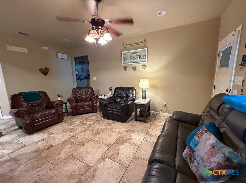 609 Highway 123 Stockdale, TX 78160 - Photo 26 of 26 a living room with furniture and a chandelier