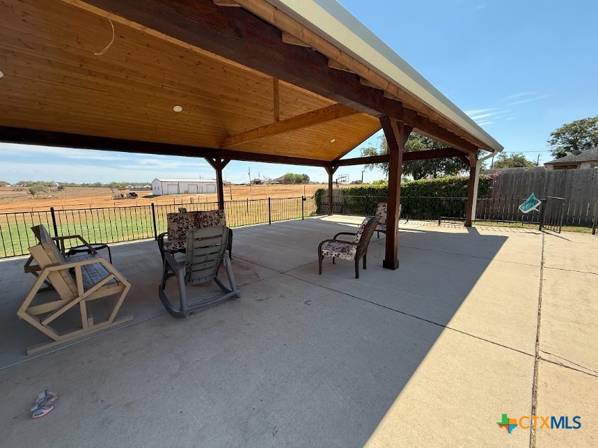 609 Highway 123 Stockdale, TX 78160 - Photo 5 of 26 a view of a patio with table and chairs under an umbrella