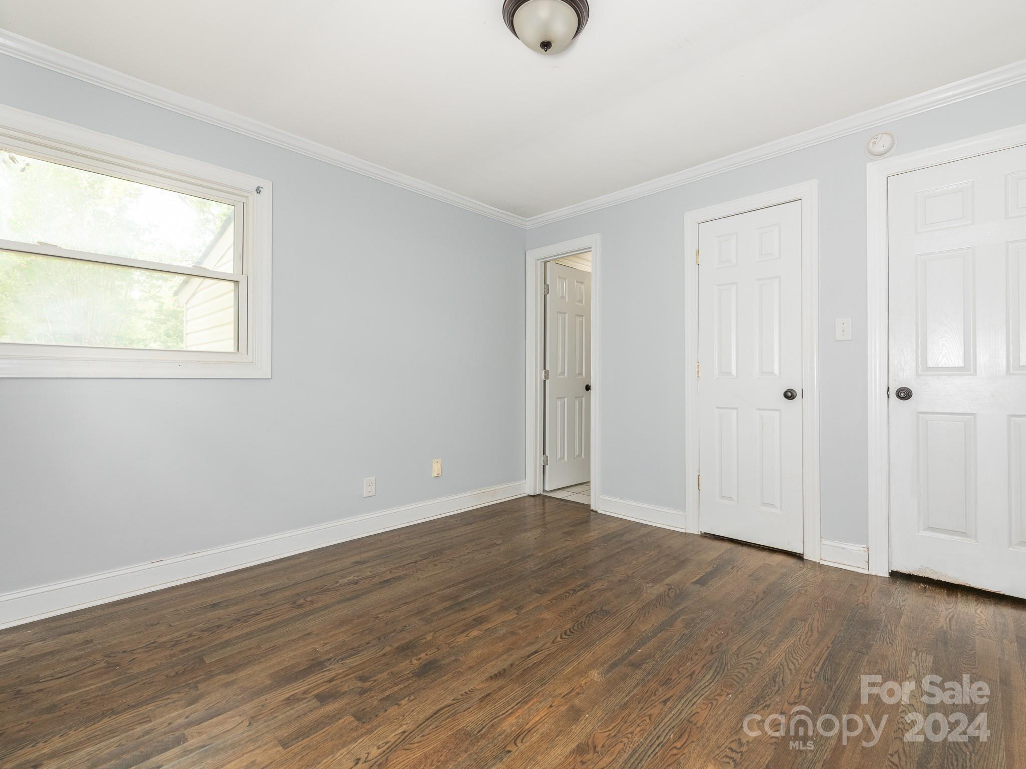 8106 Indian Trail Fairview Road Indian Trail, NC 28079 - Photo 13 of 17 an empty room with wooden floor and windows