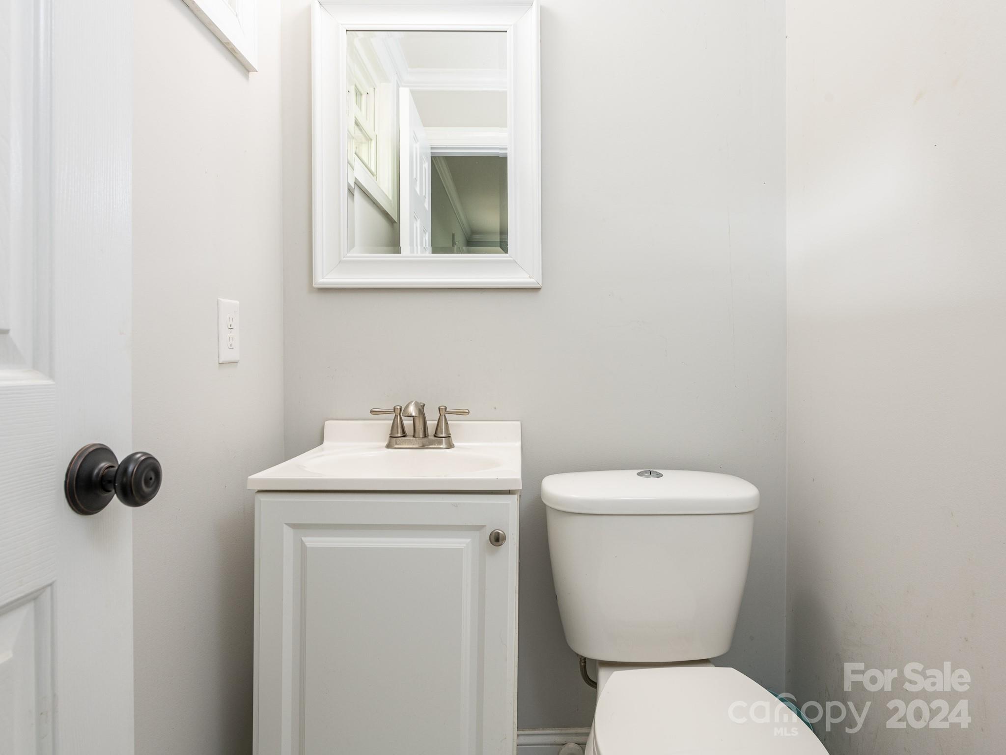 8106 Indian Trail Fairview Road Indian Trail, NC 28079 - Photo 15 of 17 a bathroom with a toilet sink and mirror