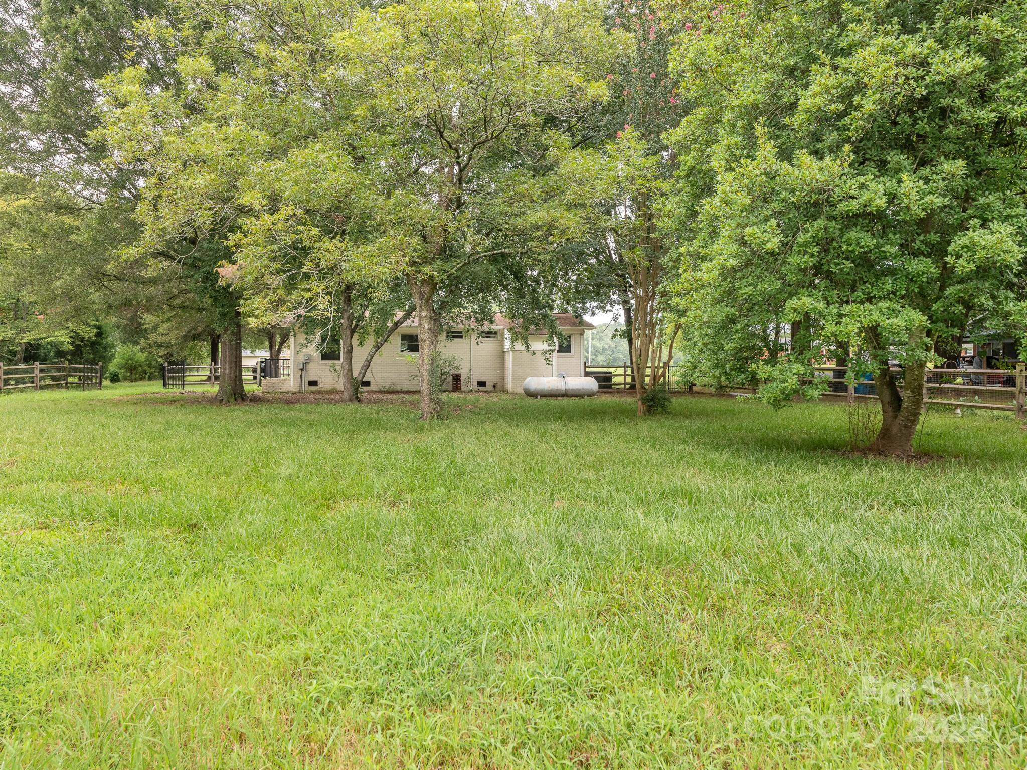8106 Indian Trail Fairview Road Indian Trail, NC 28079 - Photo 16 of 17 a view of a yard with a trees